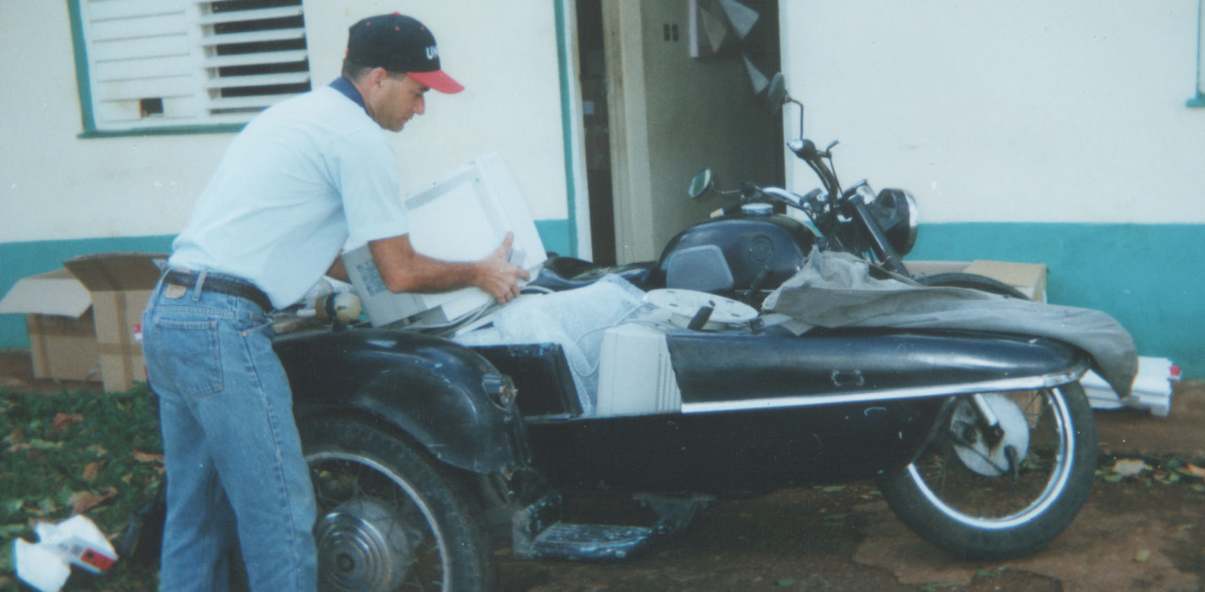 A full load: Hugo Iglesias Brito puts a third monitor on top of two others in the sidecar of the Darwin motorbike in Havana